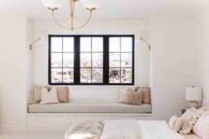 black-framed picture windows in a white, cozy room